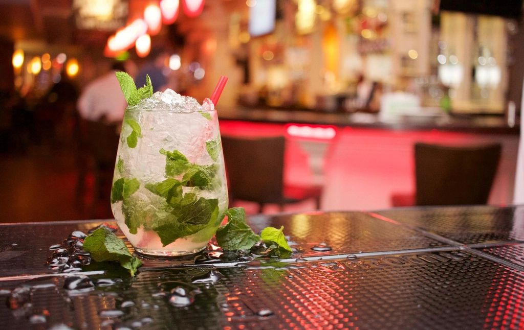 A cocktail being finished at the bar