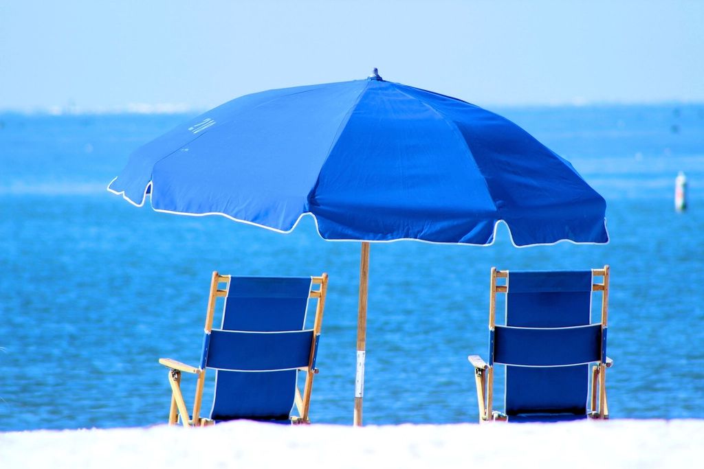Sun loungers and a parasol beside the pool