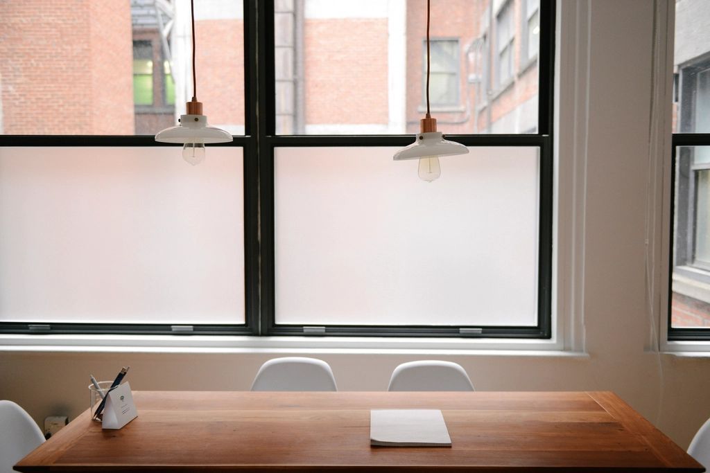 A meeting room with a long table and chairs